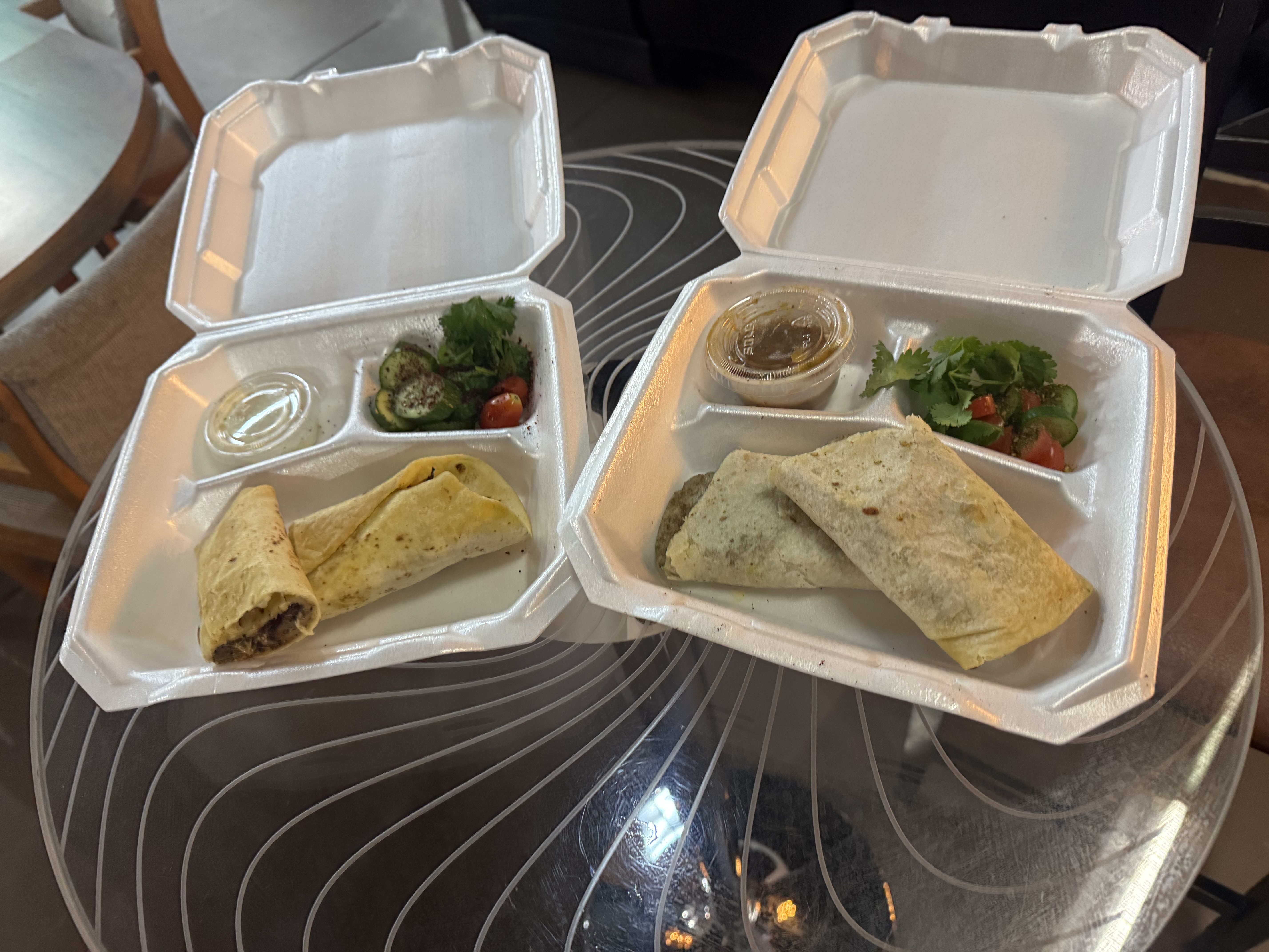 Chicken and cheese za'atar wraps served with salad and sauces at Jamila Coffee
